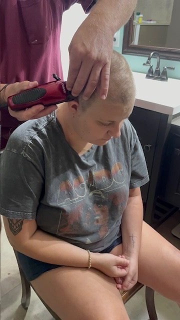 Abbi shaving her head — taking control with grace