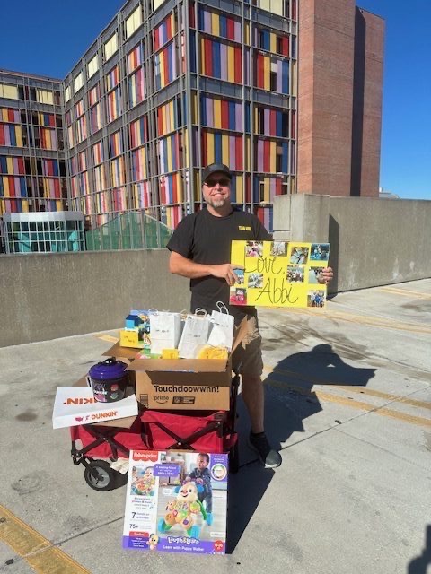 Volunteer with donations at hospital exterior
