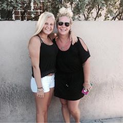 Abbi with her mom, smiling together on a sunny day